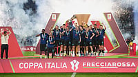 AP Photo : Inter Milan's team captain Lautaro Martinez lifts the trophy while Inter Milan head coach Cristian Chivu at left celebrates after defeating Lazio to win the Italian Cup soccer final in Rome.