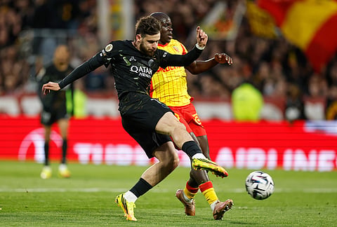 PSG's Khvicha Kvaratskhelia scores the opening goal during the French League One soccer match between Lens and Paris Saint Germain, in Lens, northern France.