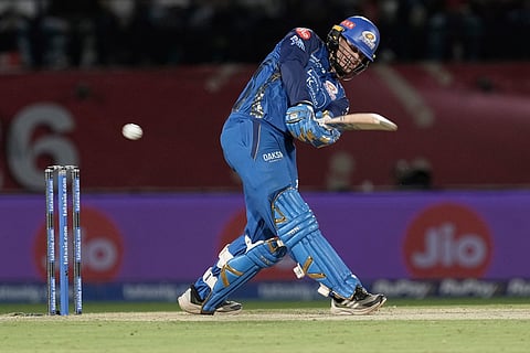 Mumbai Indians' Ryan Rickelton hits a six during the Indian Premier League cricket match between Punjab Kings and Mumbai Indians in Dharamshala, India.