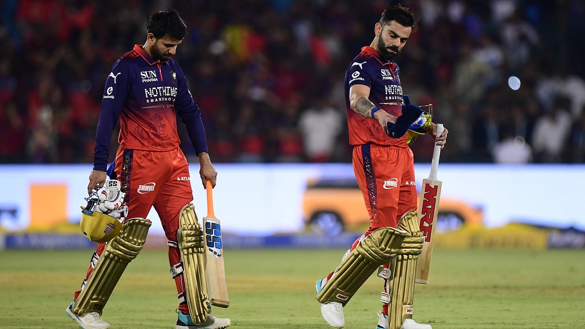 Royal Challengers Bengaluru's Virat Kohli, right, and batting partner Jitesh Sharma leave the field after winning the Indian Premier League cricket match between Kolkata Knight Riders and Royal Challengers Bengaluru in Raipur, India, Wednesday, May 13, 2026. - | PhotoL AP/Abhijit Addya