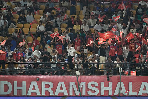 Supporters of Punjab Kings cheer for their team during the Indian Premier League cricket match between Punjab Kings and Mumbai Indians in Dharamshala, India.