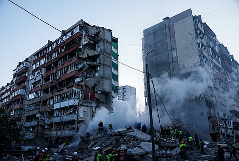 Rescue workers clear the rubble of a house heavily damaged after a Russian strike on a residential neighborhood in Kyiv, Ukraine.