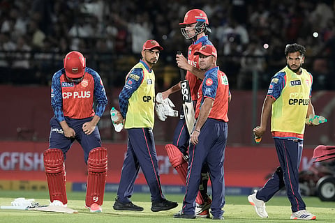Punjab Kings' head coach Ricky Ponting, second right, speaks to batsman Marco Jansen during the drinks break of the Indian Premier League cricket match between Punjab Kings and Mumbai Indians in Dharamshala, India.