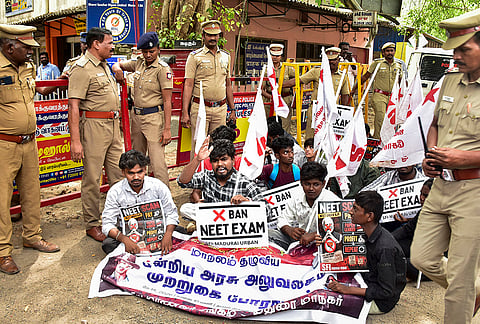 Police personnel at a protest site against the cancellation of NEET-UG 2026 over a suspected paper leak in Madurai.