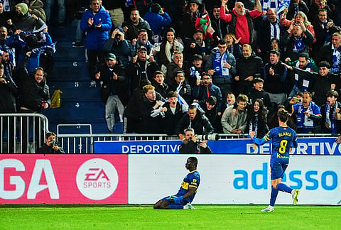 Alaves' Ibrahim Diabate, left, celebrates his side's first goal during the Spanish La Liga soccer match between Alaves and Barcelona in Vitoria-Gasteiz, Spain.