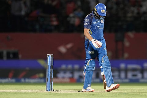 Mumbai Indians' Rohit Sharma reacts as he walks off the field after losing his wicket during the Indian Premier League cricket match between Punjab Kings and Mumbai Indians in Dharamshala, India.