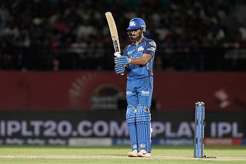 Mumbai Indians' Tilak Varma reacts after scoring his fifty runs during the Indian Premier League cricket match between Punjab Kings and Mumbai Indians in Dharamshala, India.
