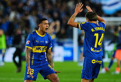 Alaves' Carlos Protesoni, left, and Alaves' Nahuel Tenaglia celebrate after the Spanish La Liga soccer match between Alaves and Barcelona in Vitoria-Gasteiz, Spain.