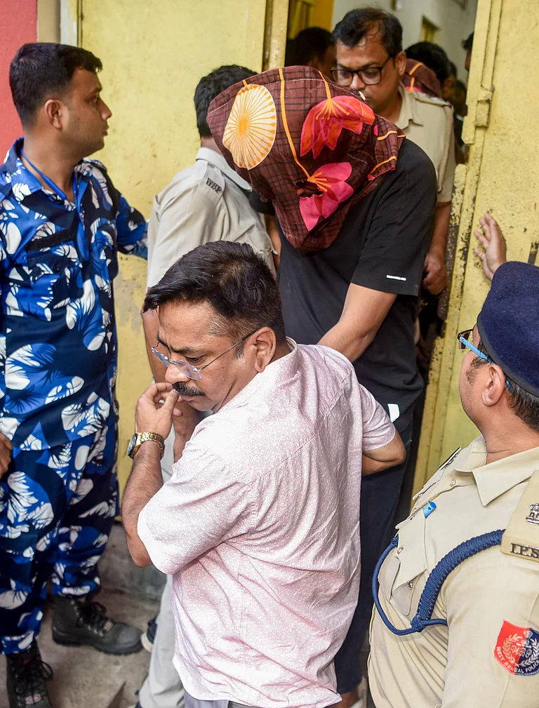Police personnel escort one of the suspects arrested in connection with the murder of Chandranath Rath, personal assistant to West Bengal Chief Minister Suvendu Adhikari, at the Barasat Court, in North 24 Parganas district, West Bengal. - PTI