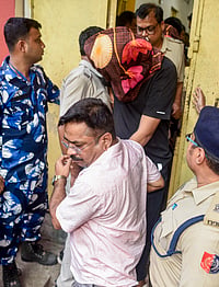 Mystery Behind Chandranath Rath's Murder Deepens AS SIT Alleges Sharpshooter Is From UP PTI : Police personnel escort one of the suspects arrested in connection with the murder of Chandranath Rath, personal assistant to West Bengal Chief Minister Suvendu Adhikari, at the Barasat Court, in North 24 Parganas district, West Bengal.