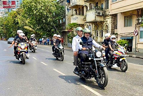 Maharashtra Chief Minister Devendra Fadnavis rides a two-wheeler, in view of Prime Minister Narendra Modi's appeal for austerity, in Mumbai. 