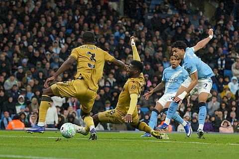 Manchester City's Omar Marmoush, right, scores his side's second goal during the English Premier League soccer match between Manchester City and Crystal Palace in Manchester, England.