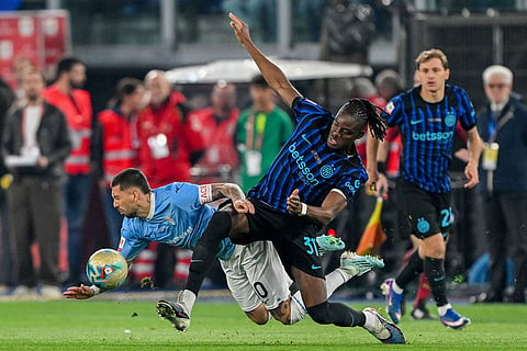 Lazio's Mattia Zaccagni, left, fights for the ball with Inter's Yann-Aurel Bisseck during the Italian Cup soccer final between Lazio and Inter Milan, in Rome.