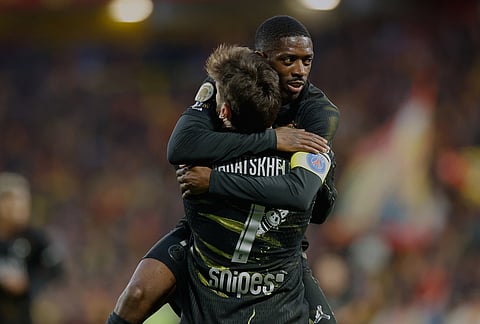 PSG''s Khvicha Kvaratskhelia celebrates with teammate Ousmane Dembele after he scored the opening goal during the French League One soccer match between Lens and Paris Saint Germain, in Lens, northern France.
