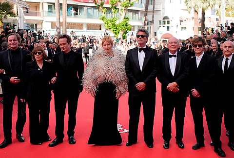 Devid Striesow, from left, Ewa Puszczynska, August Diehl, Sandra Hueller, Pawel Pawlikowski, Hanns Zischler, Lukasz Zal, and Lorenzo Mieli pose for photographers upon arrival at the premiere of the film 'Fatherland' at the 79th international film festival, Cannes, southern France.