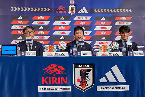 Hajime Moriyasu, center, head coach of Japan's national soccer team, accompanying Masakuni Yamamoto, left, national team director, and Tsuneyasu Miyamoto, right, president of the Japan Football Association, announces Japan's squad for the 2026 FIFA World Cup during a news conference in Tokyo. 
