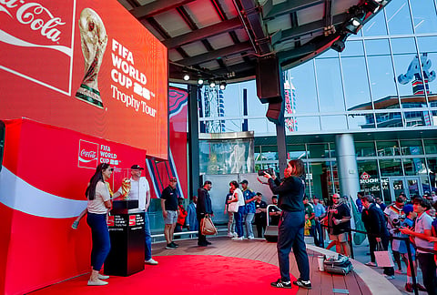 Soccer fans take photos of the trophy during the FIFA World Cup Trophy Tour before the Atlanta Braves host the Chicago Cubs in a baseball game, in Atlanta. 