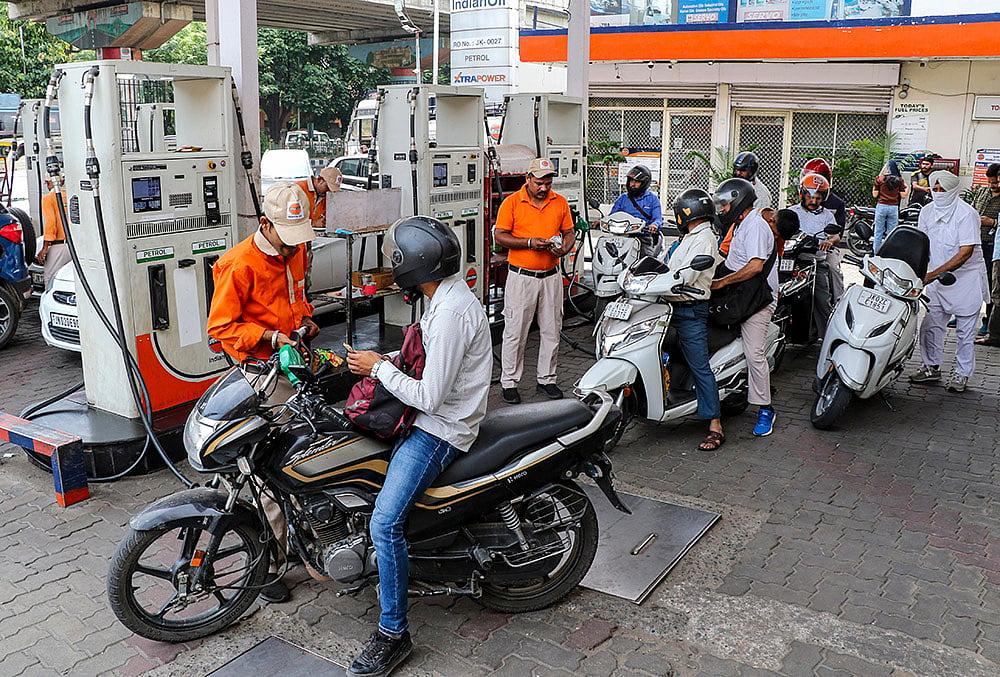 Commuters at a petrol pump after petrol and diesel prices were hiked by Rs 3 per litre each, the first increase in over four years, amid rising global crude oil prices, in Jammu, Jammu and Kashmir. - | Photo: PTI