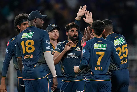 Gujarat Titans' Mohammed Siraj, centre, celebrates with teammates the wicket of Kolkata Knight Riders' captain Ajinkya Rahane during the Indian Premier League cricket match between Gujarat Titans and Kolkata Knight Riders, in Kolkata.