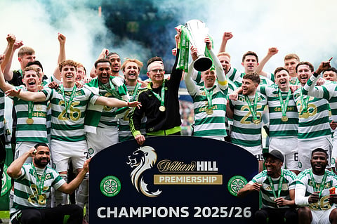 Celtic manager Martin O'Neill and Callum McGregor hold the Scottish Premier League Trophy as the team celebrate following his side's title deciding match against Heart of Midlothian at Celtic Park, in Glasgow, Scotland.