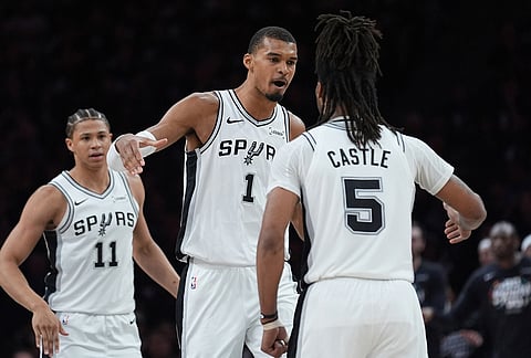 San Antonio Spurs forward Victor Wembanyama (1) celebrates a score with guard Stephon Castle (5) during the first half of Game 6 of an NBA basketball second-round playoffs series in Minneapolis.