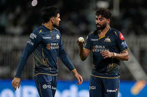 Gujarat Titans' Mohammed Siraj, right, talks to his captain Shubman Gill during the Indian Premier League cricket match between Gujarat Titans and Kolkata Knight Riders, in Kolkata.
