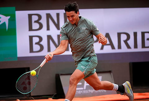 Luciano Darderi of Italy returns a ball to Casper Ruud of Norway during their semifinal match at the Italian Open tennis tournament in Rome.