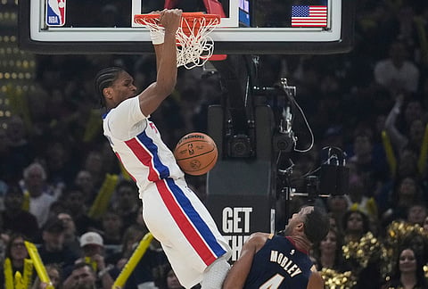 Detroit Pistons' Ausar Thompson, left, dunks over Cleveland Cavaliers' Evan Mobley, right, in the second half of Game 6 of a second-round NBA basketball playoffs series in Cleveland.