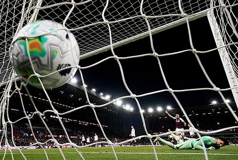 Liverpool goalkeeper Giorgi Mamardashvili is scored on by Aston Villa's John McGinn during the English Premier League soccer match between Aston Villa and Liverpool in Birmingham, England.