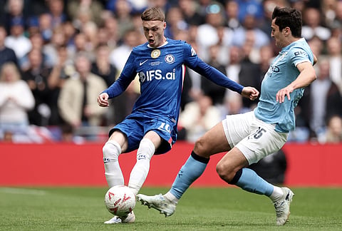 Manchester City's Abdukodir Khusanov, right, tries to block a shot from Chelsea's Cole Palmer during the English FA Cup final soccer match between Chelsea and Manchester City in London.