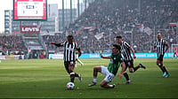 | Photo: Christian Charisius/dpa via AP : St. Pauli's Joel Chima Fujita, left, and Wolfsburg's Joakim Maehle fight for the ball during the German Bundesliga soccer match between FC St. Pauli and VfL Wolfsburg in Hamburg, Germany, Saturday, May 16, 2026. 