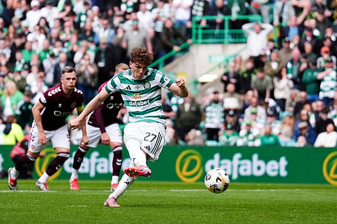 Celtic's Arne Engels scores from the penalty spot during the Premiership soccer match between Celtic and Heart of Midlothian, in Glasgow, Scotland.