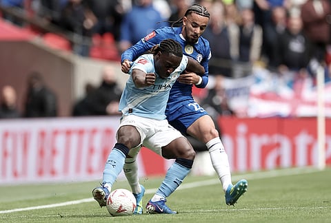 Manchester City's Jeremy Doku, front, and Chelsea's Malo Gusto challenge for the ball during the English FA Cup final soccer match between Chelsea and Manchester City in London.
