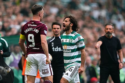Celtic's Marcelo Saracchi and Heart of Midlothian's Lawrence Shankland, left, during the Premiership soccer match between Celtic and Heart of Midlothian, in Glasgow, Scotland.