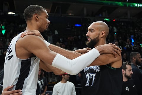 San Antonio Spurs forward Victor Wembanyama, left, and Minnesota Timberwolves center Rudy Gobert, right, greet following Game 6 of an NBA basketball second-round playoffs series in Minneapolis.