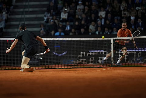 Italy's Jannik Sinner returns a ball to Daniil Medvedev of Russia during their semifinal match at the Italian Open tennis tournament in Rome.
