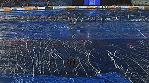 | Photo: AP/Abhijit Addya : Umpires and groundsmen inspects the field after a spell of rain before the start of Indian Premier League cricket match between Royal Challengers Bengaluru and Kolkata Knight Riders in Raipur, India.