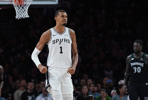 San Antonio Spurs forward Victor Wembanyama (1) reacts after scoring against the Minnesota Timberwolves during the first half of Game 6 of an NBA basketball second-round playoffs series in Minneapolis.