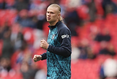 Manchester City's Erling Haaland stretches himself during warm up before the English FA Cup final soccer match between Chelsea and Manchester City in London.