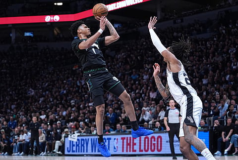 Minnesota Timberwolves guard Terrence Shannon Jr. (1) shoots over San Antonio Spurs guard Devin Vassell (24) during the first half of Game 6 of an NBA basketball second-round playoffs series in Minneapolis.