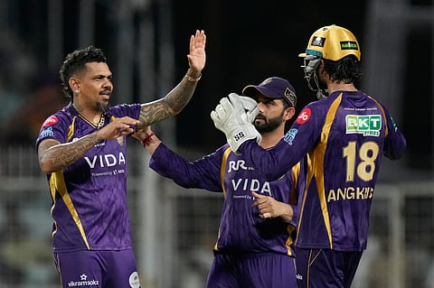 Kolkata Knight Riders' Sunil Narine, left, celebrates with captain Ajinkya Rahane, centre, and Angkrish Raghuvanshi the wicket of Gujarat Titans' captain Shubman Gill during the Indian Premier League cricket match between Gujarat Titans and Kolkata Knight Riders, in Kolkata.