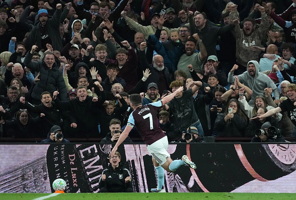 Aston Villa's John McGinn celebrates after scoring his side's fourth goal during the English Premier League soccer match between Aston Villa and Liverpool in Birmingham, England. - | Photo: AP/Dave Shopland
