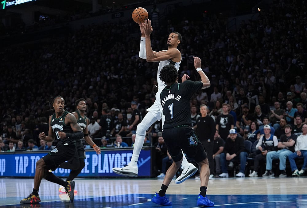 | Photo: AP/Abbie Parr : San Antonio Spurs forward Victor Wembanyama, center, passes over Minnesota Timberwolves guard Terrence Shannon Jr. (1) during the second half of Game 6 of an NBA basketball second-round playoffs series in Minneapolis.
