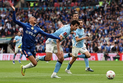 Chelsea's Joao Pedro, left, and Manchester City's Abdukodir Khusanov challenge for the ball during the English FA Cup final soccer match between Chelsea and Manchester City in London.