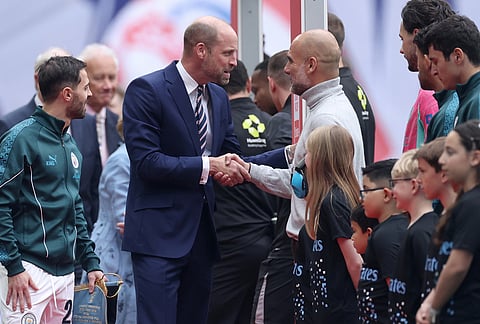 Britain's Prince William, center left, shakes hands with Manchester City's head coach Pep Guardiola before the English FA Cup final soccer match between Chelsea and Manchester City in London.