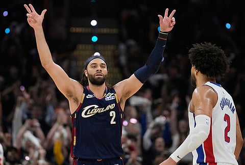 Cleveland Cavaliers Max Strus (2) celebrates a three-point basket in front of Detroit Pistons' Cade Cunningham, right, in the first half of Game 6 of a second-round NBA basketball playoffs series in Cleveland. 