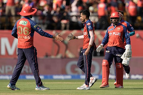 Punjab Kings' Yuzvendra Chahal, second right, celebrates the wicket of Royal Challengers Bengaluru's Virat Kohli during the Indian Premier League cricket match between Punjab Kings and Royal Challengers Bengaluru in Dharamshala, India.