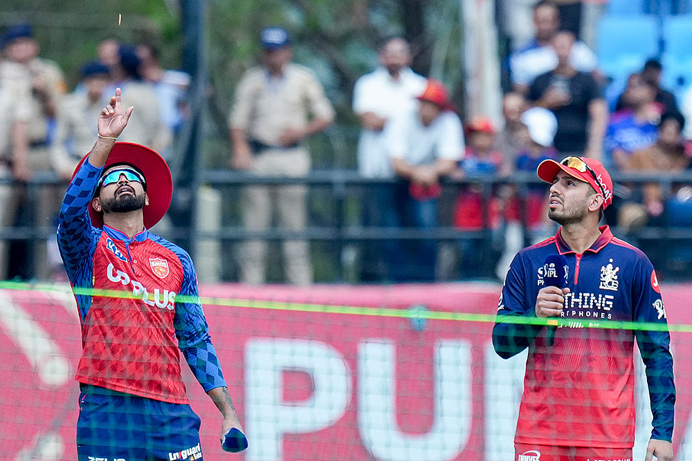 Punjab Kings’ captain Shreyas Iyer, left, and Royal Challengers Bengaluru’s Jitesh Sharma during the toss before an Indian Premier League (IPL) 2026 T20 cricket match between Punjab Kings and Royal Challengers Bengaluru, in Dharamshala, Himachal Pradesh. - | Photo: PTI/Karma Bhutia