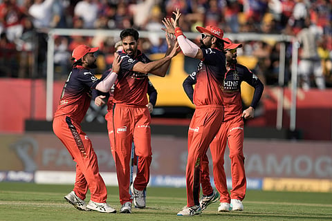 Royal Challengers Bengaluru's Bhuvneshwar Kumar, second left, celebrates with teammates the wicket of Punjab Kings' Priyansh Arya during the Indian Premier League cricket match between Punjab Kings and Royal Challengers Bengaluru in Dharamshala, India.