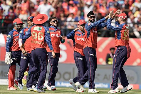 Punjab Kings' Harpreet Brar, second right, celebrates with teammates the wicket of Royal Challengers Bengaluru's Jacob Bethell during the Indian Premier League cricket match between Punjab Kings and Royal Challengers Bengaluru in Dharamshala, India.